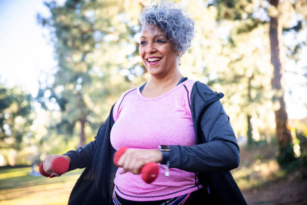 istock Senior Black Woman Stretching and Exercising with Weights 1299849165