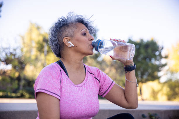 istock Black Woman Hydrating after Workout 1299849277