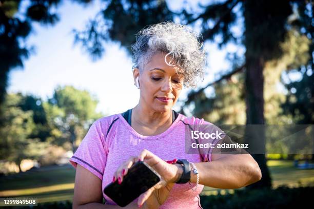 Senior Black Woman Running With A Fitness Tracker Stock Photo - Download Image Now - Smart Watch, Fitness Tracker, Walking