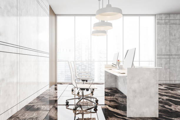 istock White marble reception room with desk, computer and chairs in office lobby 1299850349