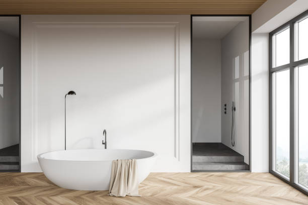 istock White loft bathroom interior with bathtub and shower 1299850394