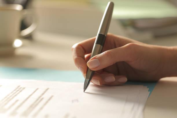 istock Profile of woman hand singing contract at office 1299850651