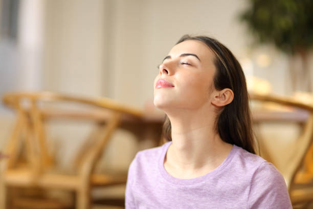 istock Woman breathing fresh air relaxing at home 1299850793