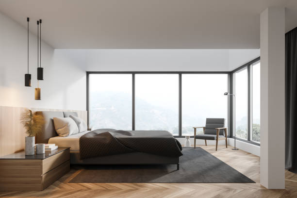 istock White master bedroom interior with bed and armchair 1299851770