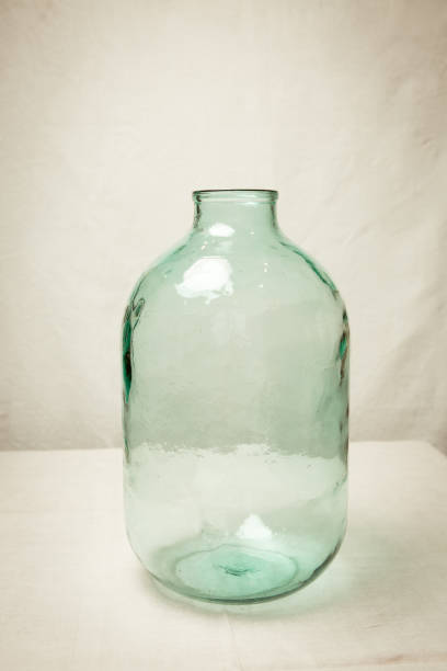 istock Large empty glass bottle with a volume of 10 liters. Capacity for storing liquid, alcohol, preservation. 1299851793