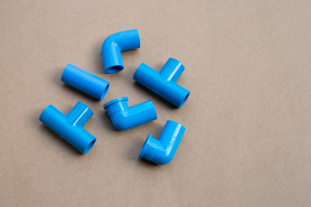 istock Blue pvc pipe connection on brown paper background. 1299859858