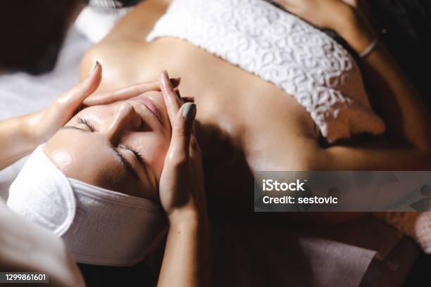 Happy Woman Receiving A Beauty Treatment Stock Photo - Download Image Now - Facial Mask - Beauty Product, Spa, Women