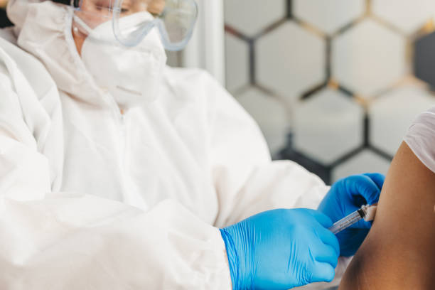 istock Vaccinating a young man in doctor's office 1299862731