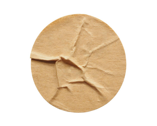 istock Brown round paper sticker label isolated on white background 1299866511