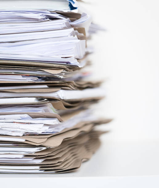 Extremely Close up Stack of Documents Folders on Office Desk Waiting to be Completed stock photo