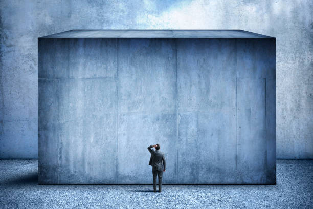 istock Man Looking Up At Large Concrete Block 1299876594