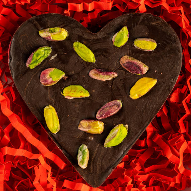 Heart-shaped chocolate with pistachio. Gift for lover. stock photo
