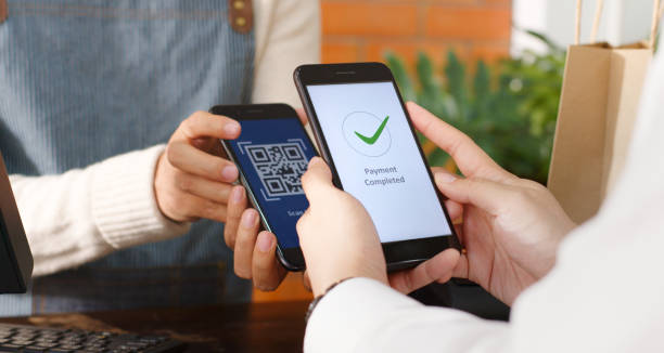 istock Customer using phone for payment at cafe restaurant, cashless technology and money transfer concept 1299881281
