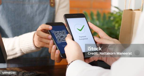 Customer Using Phone For Payment At Cafe Restaurant Cashless Technology And Money Transfer Concept Stock Photo - Download Image Now