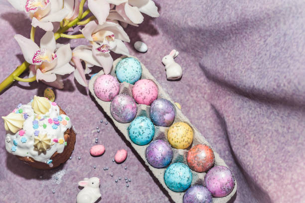 istock Special easter cake Kulich with the remit and dyed eggs. Cosmos painted eggs with white rabbits. Easter composition 1299884519