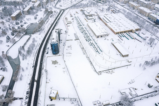 aerial view of tram depot in urban industrial district. winter cityscape. drone photo