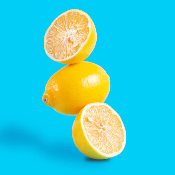 istock Three pieces of lemon levitation food on blue background 1299889941
