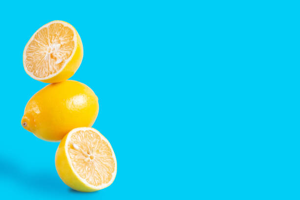 istock Three pieces of lemon levitation food on blue background copy space 1299890008