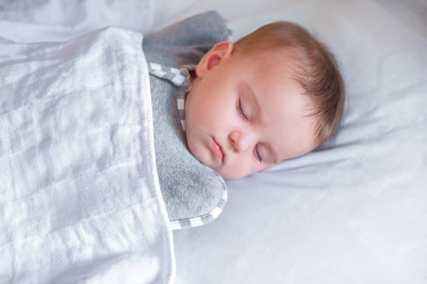 istock Cute baby sleeps in the crib. 1299892152