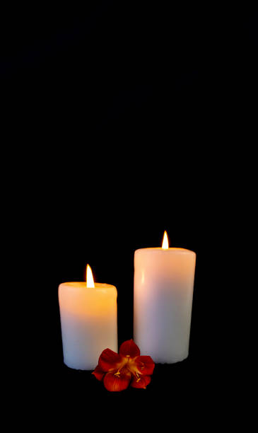 istock Candle on a black background, postcard, Flat Lai on death and funeral 1299893854