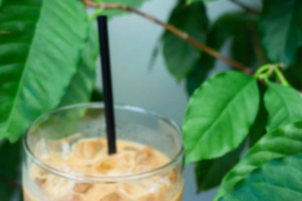 istock Iced milk coffee drink in green plant area 1299896411