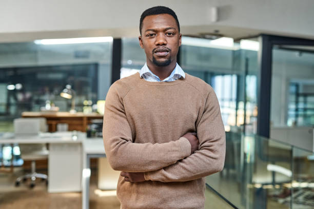 Nothing will stop me from achieving greatness Portrait of a confident young businessman standing in an office blank expression stock pictures, royalty-free photos & images