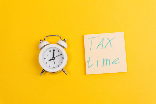 istock Tax time flat lay composition on yellow background. copy space 1299898791