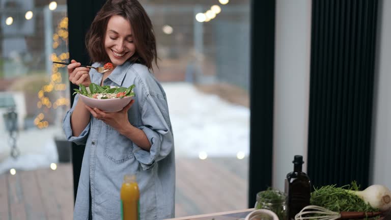 Woman feeling well with healthy food at home