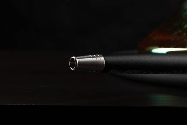 istock Mouthpiece of modern hookah on black background 1299898925