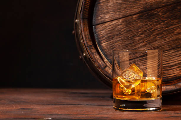 istock Scotch whiskey glass and old barrel 1299900765