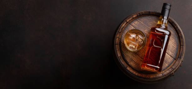 Scotch whiskey bottle, glass and old barrel Scotch whiskey bottle, glass and old wooden barrel. With copy space. Top view flat lay cognac brandy photos stock pictures, royalty-free photos & images