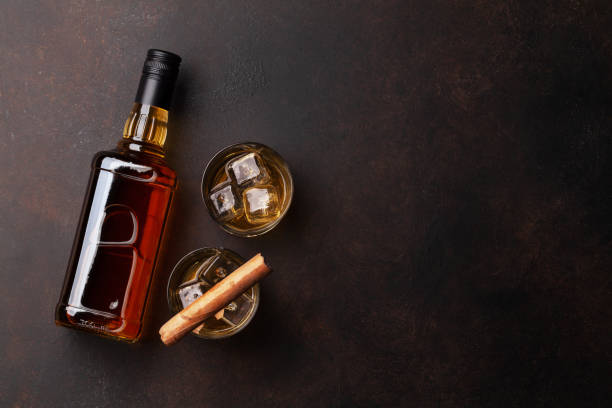 istock Scotch whiskey bottle, glasses and cigar 1299900790