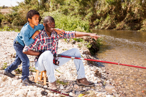 istock Man and his son fishing 1299901988