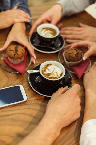 istock Friends enjoying coffee and muffins at the cafe 1299902219