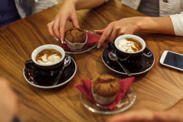 istock Enjoying muffins with coffee in a cafe 1299902247
