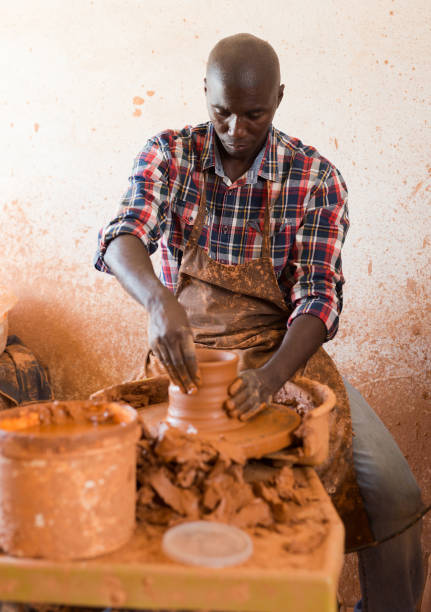 istock Craftsman woring with clay on potter wheel 1299902901