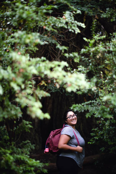 istock Hispanic Woman Hiking In a Beautiful Forest 1299905190