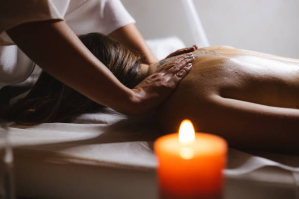 istock Young woman relaxing during back massage at the spa 1299905339