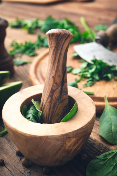 Mortar and Pestle with fresh herbs Fresh herbs and spices on wooden table mezzaluna stock pictures, royalty-free photos & images