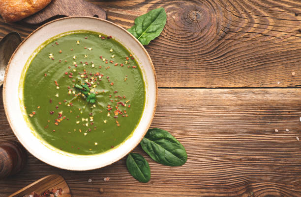 Spinach soup in a bowl with toasted bread. Top view. Copy space.