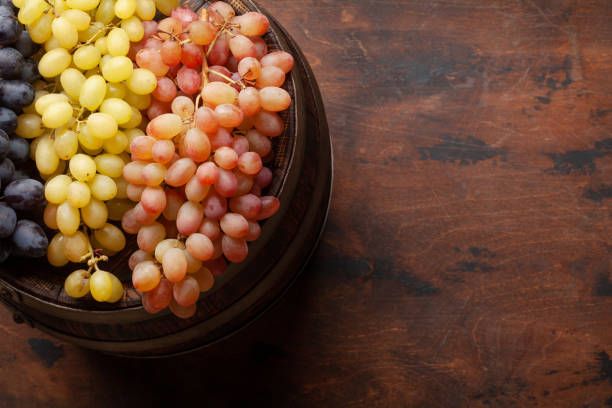 istock Various grapes on old wooden barrel 1299905754