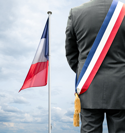 The French tricolor that flies in the wind with a mayor
