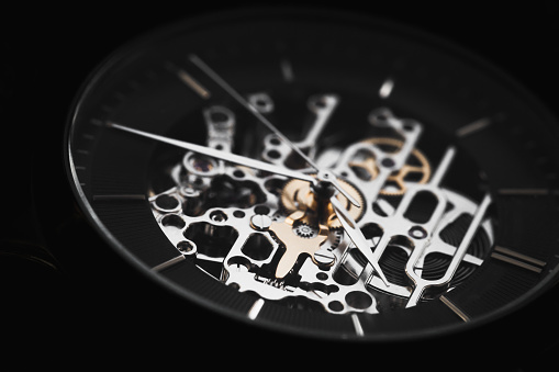 Skeleton watch macro photo. It is a mechanical watch type in which all of the moving parts are visible