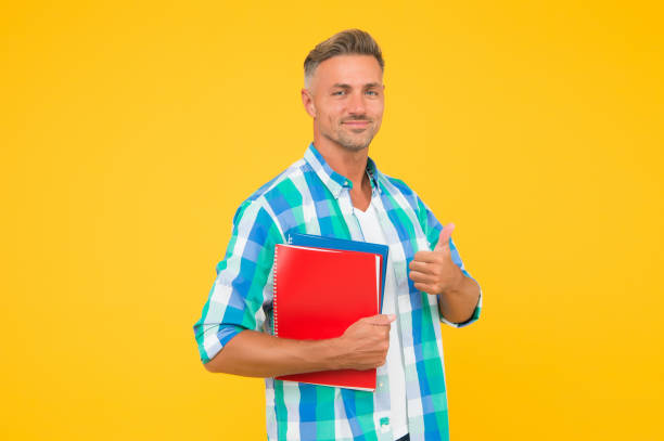 istock Free courses. Keep learning. College university education. Man adult student. Graduation concept. Dedicated to studying. Student with textbooks. Regular student carry workbooks. Student life 1299911095