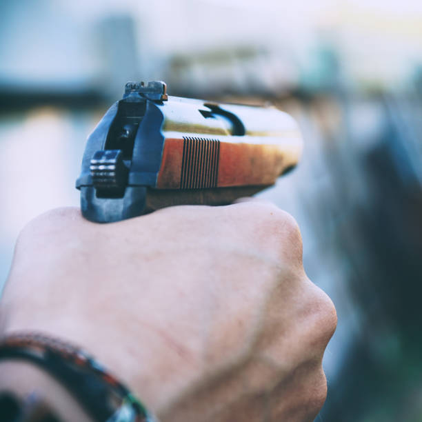istock Gun in the hands of man 1299914242