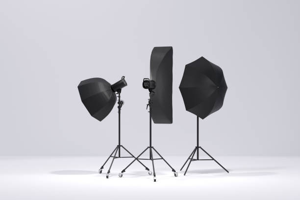 istock Photo studio lighting stands with flash, umbrella and softbox on the white 1299918478