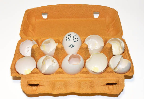 istock Chicken egg in a cardboard with painted emotions on shell among broken empty eggs in a paperboard 1299919335