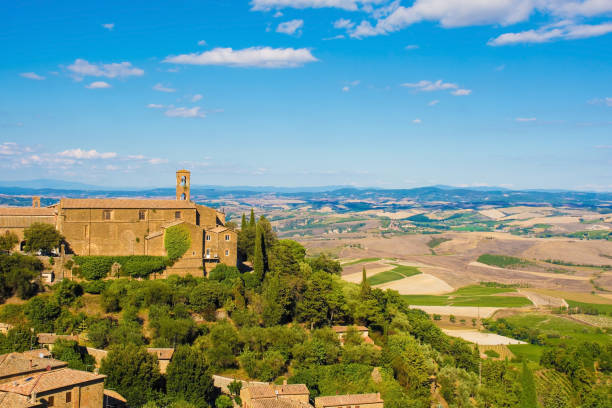Montalcino in Tuscany Residential buildings and a church in the historic medieval village of Montalcino in Siena  province, Tuscany, Italy crete senesi stock pictures, royalty-free photos & images