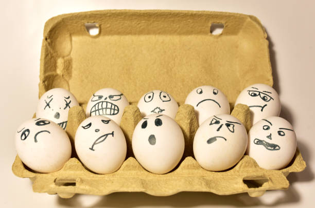 istock Chicken eggs in a cardboard box with painted emotions on the shell. 1299919812