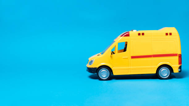 istock The toy van is yellow with flashing lights on a blue background with a place for copyspace text for the toy store 1299921301